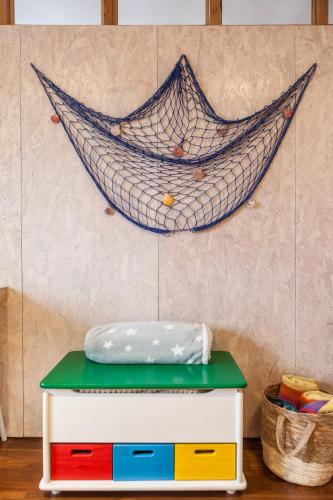 a hammock hanging on a wall next to a shelf at Apartamento El Espigón (Cimadevilla) in Gijón