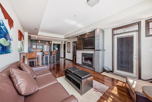 a living room with a couch and a fireplace at Copper Point Resort in Invermere