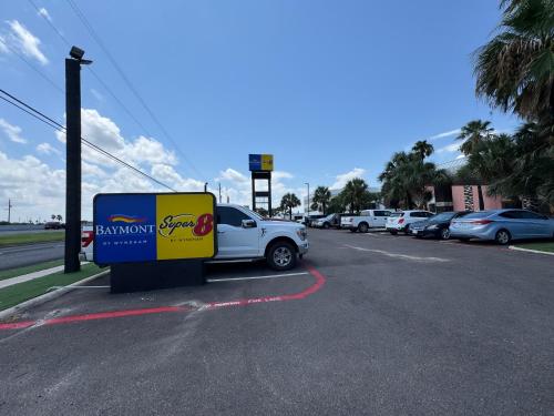 a gas station with a car parked in a parking lot at Baymont by Wyndham Corpus Christi Airport in Corpus Christi