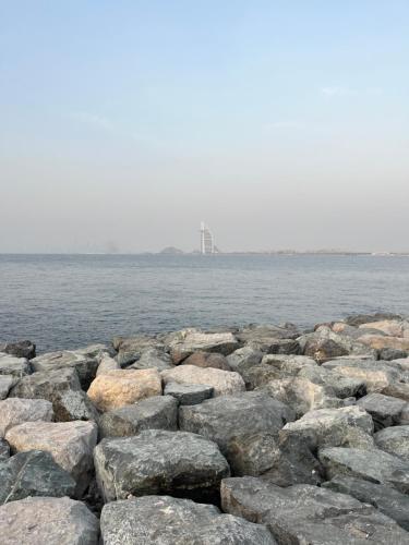 a large group of rocks on the water at Blue Water Beach Homestay - Private beach DH in Kalyānpur