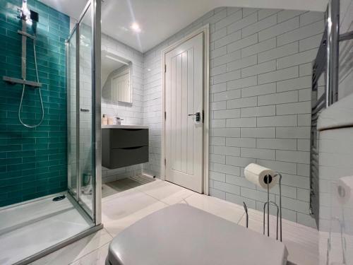 a bathroom with a shower and a toilet at Allerton Loft - Beautiful peaceful apartment in Liverpool