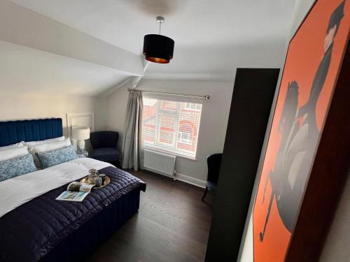 a hotel room with a bed and a window at Allerton Loft - Beautiful peaceful apartment in Liverpool