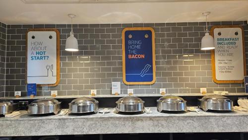 a row of pots and pans on a counter in a kitchen at Holiday Inn Express - Wigan by IHG in Wigan