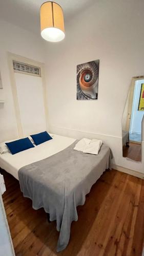 a bedroom with two beds and a painting on the wall at Sweet Alfama, Apartment 2 in Lisbon