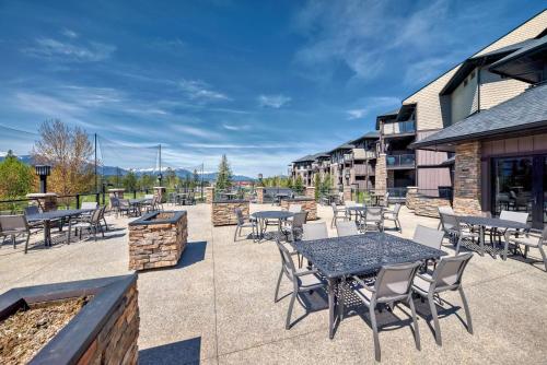 a patio with tables and chairs on a building at Copper Point Resort in Invermere
