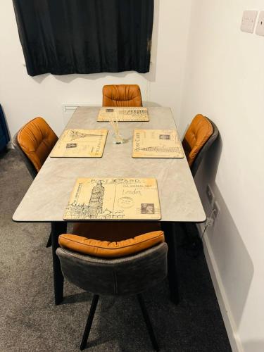 a table with chairs and papers on top of it at Canvey Stay Entire Flat in Canvey Island
