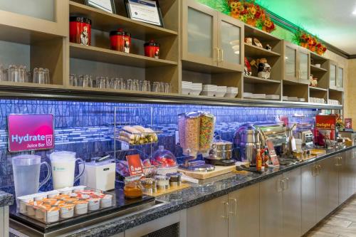 a kitchen with a counter with some food on it at Best Western Plus Emerald Inn & Suites in Garden City