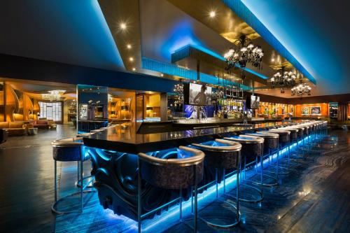 a bar with bar stools at a nightclub at Hard Rock Hotel Riviera Maya - All Inclusive in Puerto Aventuras