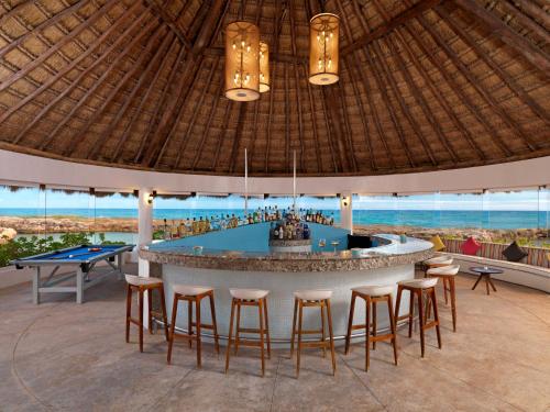 a bar in a resort with a pool table at Hard Rock Hotel Riviera Maya - All Inclusive in Puerto Aventuras
