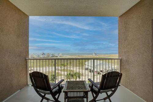 two chairs and a table on a balcony with a view at The Dunes 507 by Vacation Homes Collection in Gulf Shores