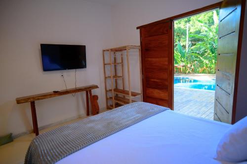 En eller flere senge i et værelse på Villa Beija Flor