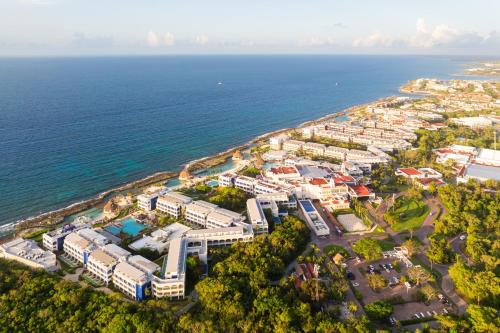an aerial view of a city next to the ocean at Hard Rock Hotel Riviera Maya - All Inclusive in Puerto Aventuras