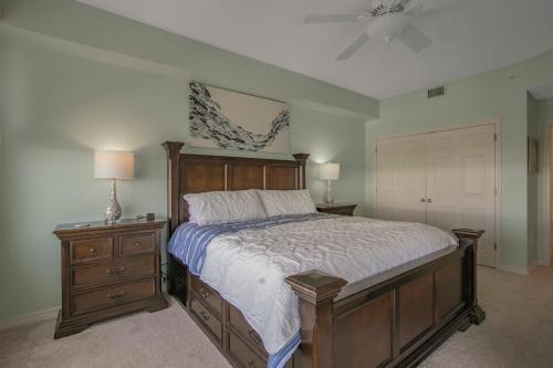 a bedroom with a bed and two night stands and two lamps at Navy Cove Harbor 1205 by Vacation Homes Collection in Fort Morgan