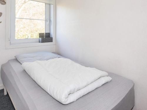 a bed in a white room with a window at Scenic Pool House Retreat - By Traum Ferienwohnungen in Thyholm