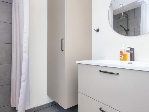 a white bathroom with a sink and a mirror at 8 person holiday home in Skjern-By Traum in Skjern
