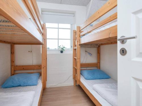 two bunk beds in a room with a window at Luxury Retreat with Pool in Ulfborg