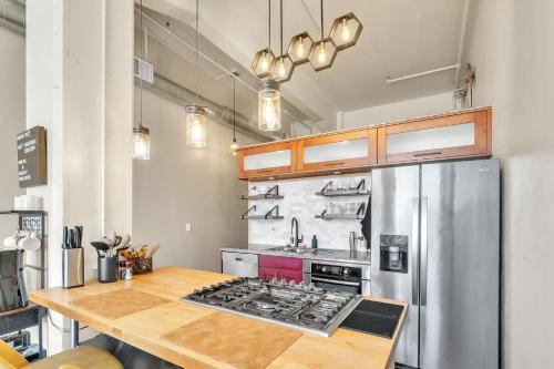a kitchen with a stove and a stainless steel refrigerator at Modern Condo with Mountain Views, Walk to Downtown condo in Salt Lake City