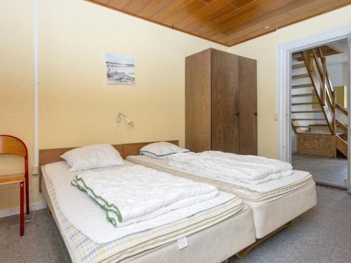 two twin beds in a room with a staircase at Luxury Pool House Retreat - By Traum Ferienwohnungen in Skjern
