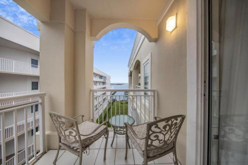 a balcony with two chairs and a table at Perdido Grande 2502 by Vacation Homes Collection in Orange Beach