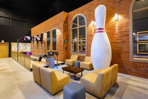 a lobby with couches and a large vase at Hard Rock Hotel Riviera Maya - All Inclusive in Puerto Aventuras