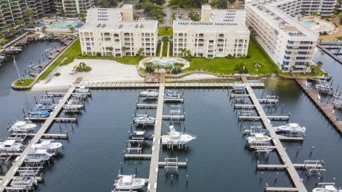a marina with boats in the water next to buildings at Perdido Grande 2502 by Vacation Homes Collection in Orange Beach