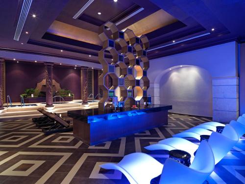 a room with a stage with white chairs at Hard Rock Hotel Riviera Maya - All Inclusive in Puerto Aventuras