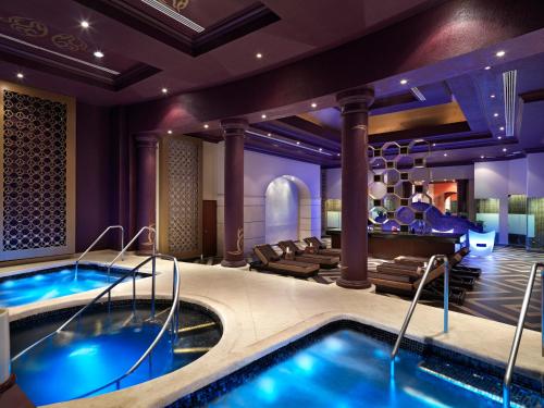 a hotel room with a swimming pool and a lobby at Hard Rock Hotel Riviera Maya - All Inclusive in Puerto Aventuras