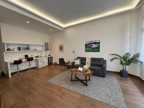 a living room with a couch and a table at Casa Herrmann Suites in Mexico City