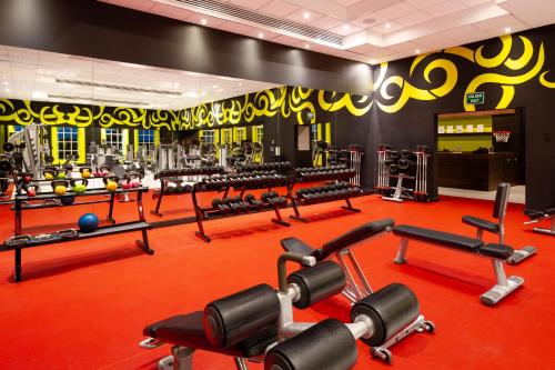 a gym with a lot of equipment in it at Hard Rock Hotel Riviera Maya - All Inclusive in Puerto Aventuras