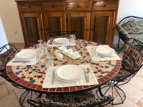 a table with plates and napkins on top of it at Chez Souleyman et Halimatou in Mbour