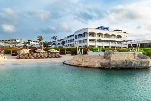 a resort with a fountain in the middle of the water at Hard Rock Hotel Riviera Maya - All Inclusive in Puerto Aventuras
