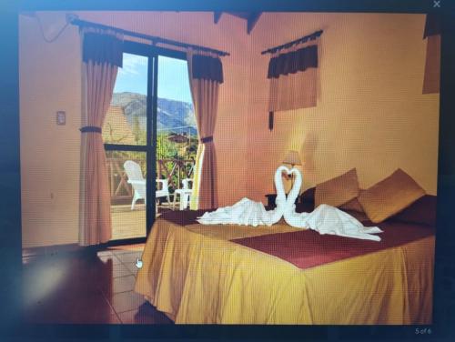 Postel nebo postele na pokoji v ubytování AMALGAMA CABAÑAS