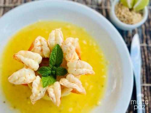 a bowl of soup with shrimp on top of it at Muita Paz in Atins