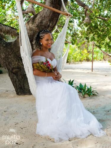 a woman in a white dress on a swing at Muita Paz in Atins