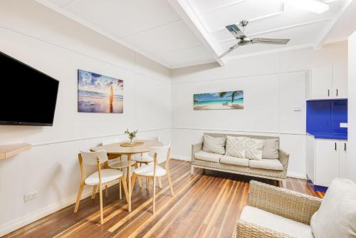 a living room with a table and a couch at Tondio Terrace Flat 3 - Pet Friendly in Gold Coast