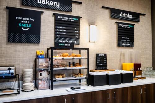 a bakery with a counter with pastries on it at Holiday Inn Cody - Convention Center by IHG in Cody