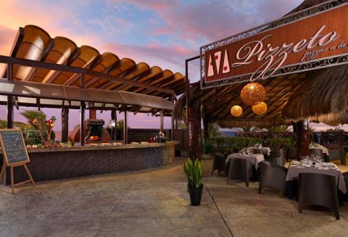 a rendering of a restaurant with tables and chairs at Hard Rock Hotel Riviera Maya - Heaven Adults Only - All Inclusive in Puerto Aventuras