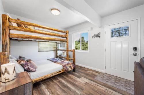 a bedroom with a bunk bed and a door at Julian Cafe Cottages With Breakfast At The Julian Cafe in Julian