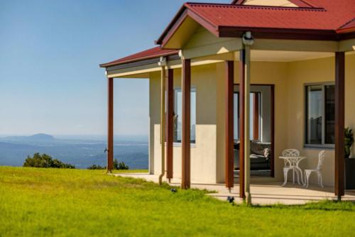 a house on a hill with a view of the ocean at Petrichor Estate - 360 Views Pool & Spa in Bald Knob