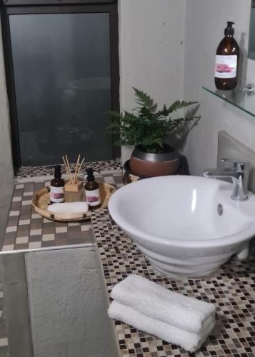 a bathroom with a tub and a sink with towels at La Dolce Vita in Hoedspruit