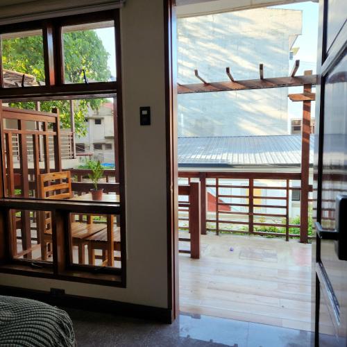 a room with a door open to a patio with a table at Inngo Tourist Inn in El Nido