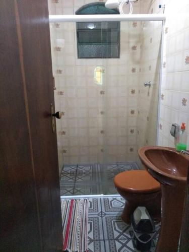 a bathroom with a shower and a toilet and a sink at Chácara dos Sonhos em Mairiporã in Mairiporã