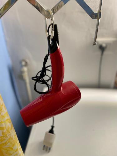 a red object is hanging from a hook at Villa Salina - Vicina al mare con giardino privato in Trabia