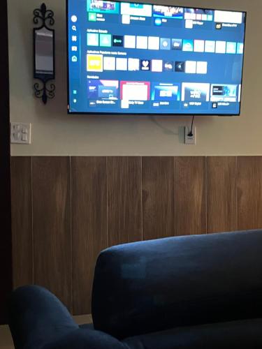 a flat screen tv hanging on a wall at Cabanas Cantareira - Araucária in Mairiporã