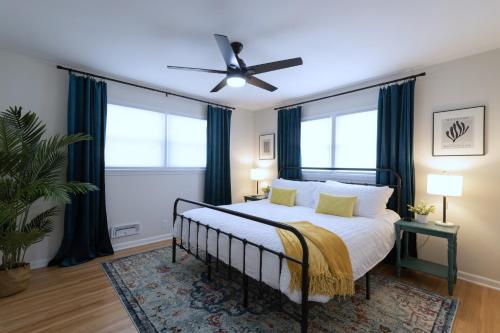 a bedroom with a bed with a ceiling fan at Vintage Modern Mid-Century Gem in Omaha