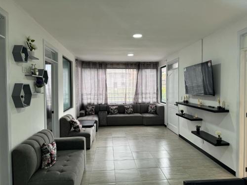 a living room with a couch and a tv at M&J apartment in Cuenca