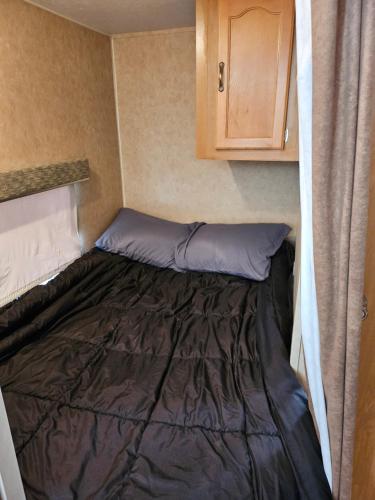 a bed in the corner of a small room at Comanche Teepee at Nomad Landing in Clayton