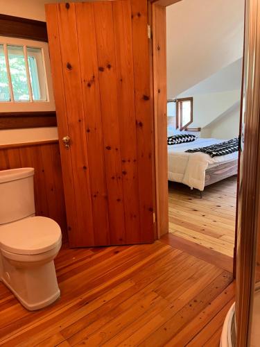 a bathroom with a toilet and a bed in a room at Boho Loft in Downtown Wakefield in Wakefield