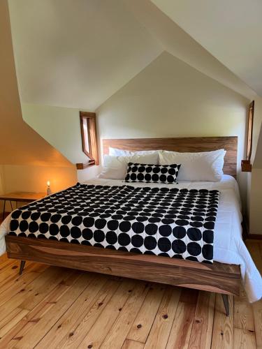 a bedroom with a large bed with black and white sheets at Boho Loft in Downtown Wakefield in Wakefield