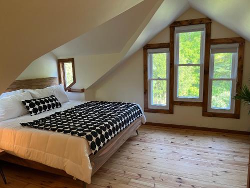 una camera da letto con un letto in una stanza con finestre di Boho Loft in Downtown Wakefield a Wakefield